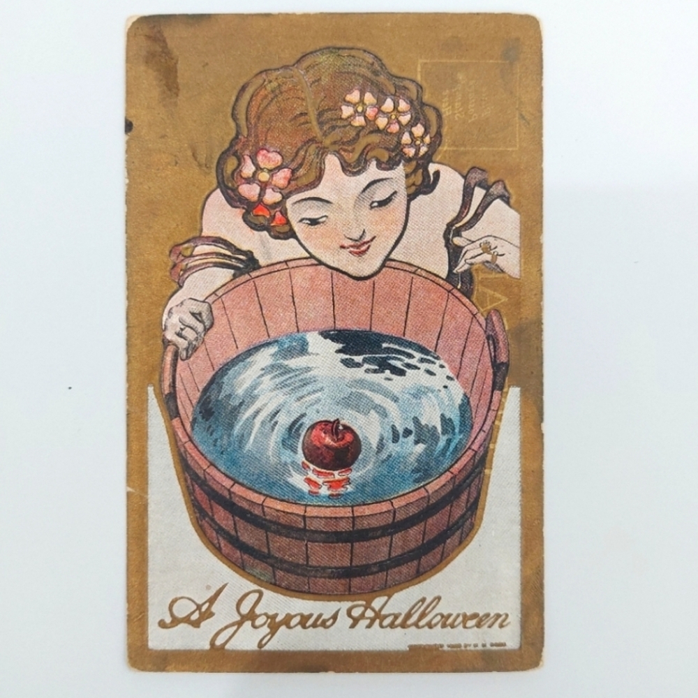 Vintage postcard c1914 A Joyous Halloween woman bobbing for apples